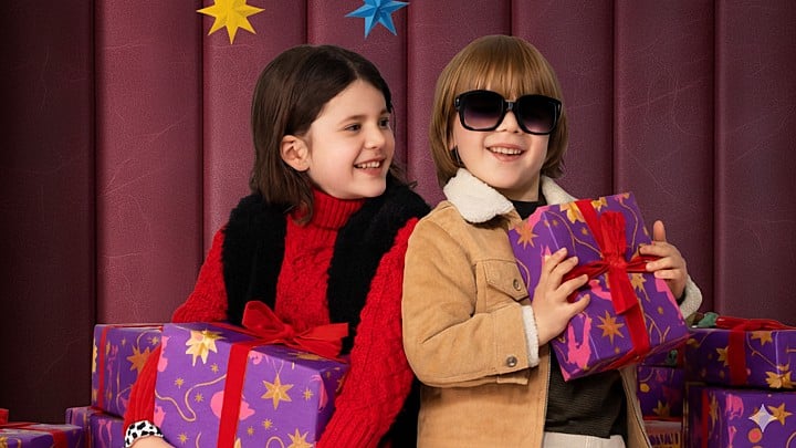 Image of a kids with gift boxes on dark background